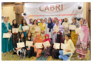 A group of baking and cooking arts students joyfully accepting their certificate awards at a formal event.